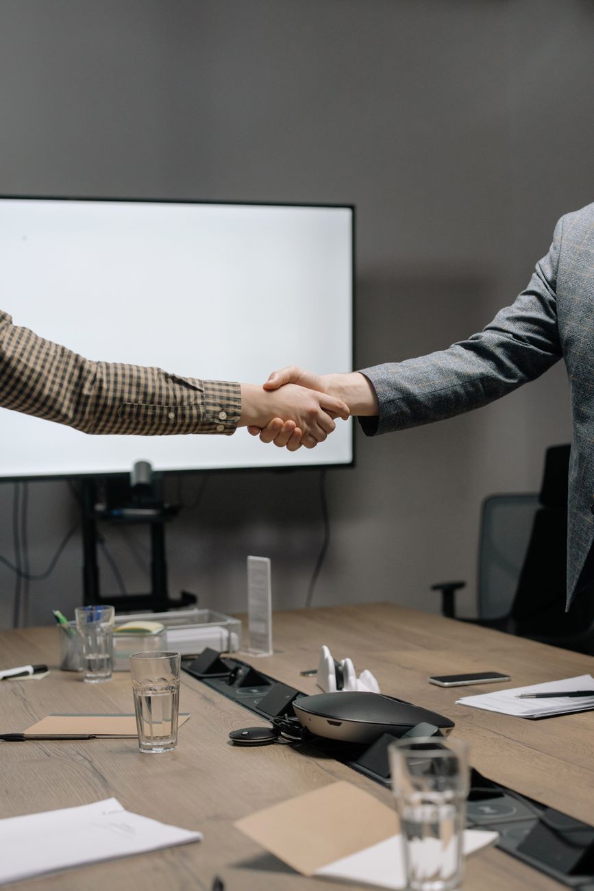 Business handshake in Tokyo boardroom